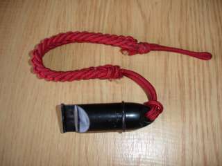 This is a vintage signal whistle on lanyard.Made of black bakelite 